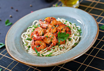 Pasta spaghetti with shrimps, tomato and chopped parsley. Healthy food. Italian meal.