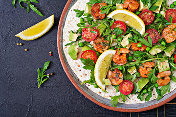 Shrimps tortilla tacos open face wrap with fresh vegetables. Healthy food. Mexican meal. Top view. Flat lay