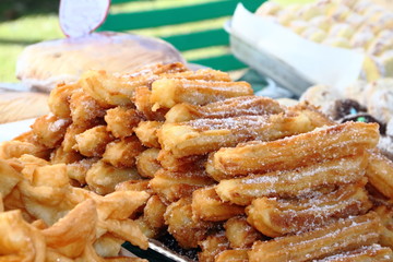 alfajores fried cakes and churros for sale at the street fair