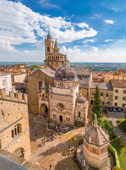 Aerial view of the Basilica of Santa Maria Maggiore and Cappella Colleoni in Citta Alta of Bergamo, Italy on a sunny day - obrazy, fototapety, plakaty