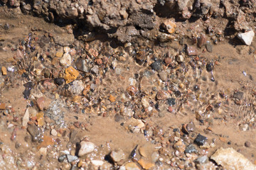 brown natural wet rocks in river water background
