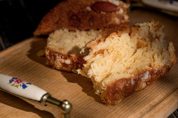 Cut Easter slices or lavish baked with almonds lie on a wooden tray