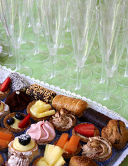 Wedding reception with flute glasses and a tray of pastries