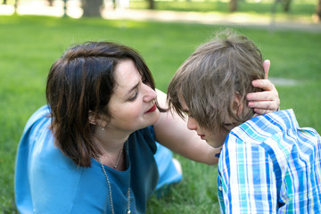 Mom or grandmother tenderly calms a son or grandson.