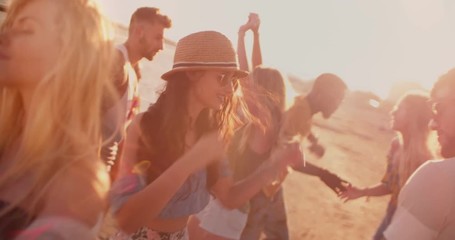 Multi-ethnic hipster friends dancing at summer beach party at sunset - Powered by Adobe