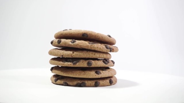 Cookies with chocolate crumbs on a White table, rotation 360 degrees. Beautiful white background.