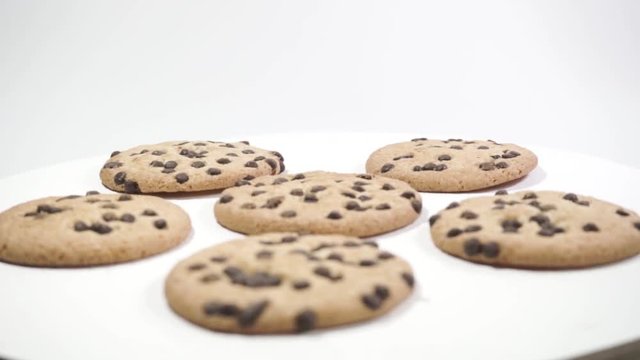 Cookies with chocolate crumbs on a White table, rotation 360 degrees. Beautiful white background.