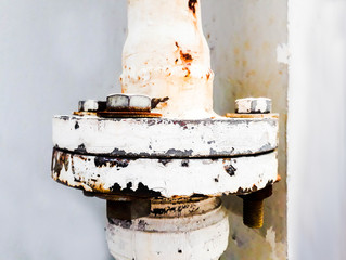 joint of two flanges by bolts and nuts, Bolts base Blurred soft focus,  Fastening base column, Old...