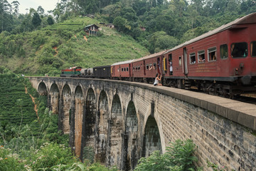 Fototapeta na wymiar Train crossing Nine Arches bridge, Ella, Sri Lanka