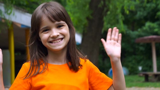 Cheerful Smiling Girl In A Garden. Close up portrait of litle girl.