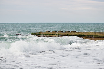 Waves on the sea near the pier overcast