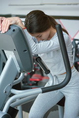 Young woman running on treadmill. Beautiful young woman in gym.