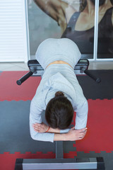 Fitness model makes hyperextensions for the back