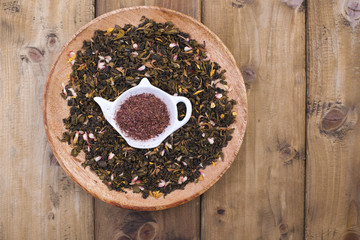 Different tea with flowers and herbs on a wooden background. Aromatherapy and health. Copy space