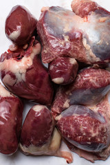 Isolated bird chicken giblets gizzards stomachs, hearts . Raw uncooked chicken turkey gizzards.