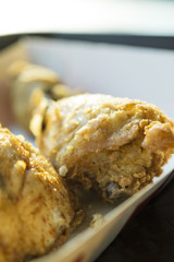 Close-up of crispy fried chicken drumstick