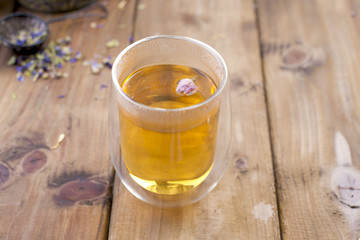 A mix of herbal tea with lavender, on a wooden background. Vintage photo. Free space for the text. Copy space.
