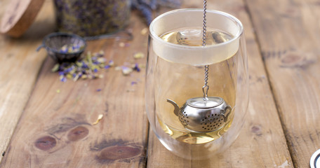 A mix of herbal tea with lavender, on a wooden background. Vintage photo. Free space for the text. Copy space.
