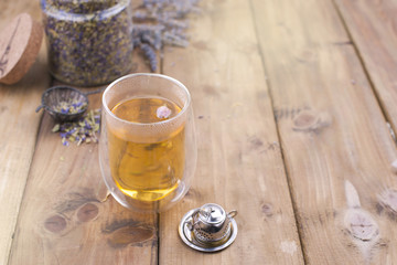 A mix of herbal tea with lavender, on a wooden background. Vintage photo. Free space for the text. Copy space.