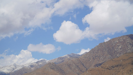 Mountain peak with some clouds and clear blue sky