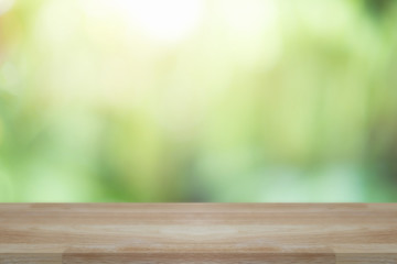 Empty wooden desk of free space and spring time with blurred background of home garden for a catering or food background,Template mock up for display montages of product.