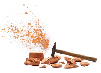 Shattered brick pieces and hammer isolated on white background, design element, with clipping path