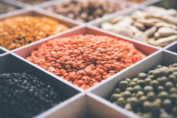 Indian Beans,Pulses,Lentils,Rice and Wheat grain in a white wooden box with cells, selective focus.