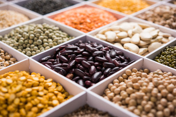 Indian Beans,Pulses,Lentils,Rice and Wheat grain in a white wooden box with cells, selective focus.
