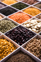 Indian Beans,Pulses,Lentils,Rice and Wheat grain in a white wooden box with cells, selective focus.