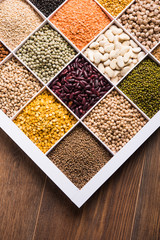 Indian Beans,Pulses,Lentils,Rice and Wheat grain in a white wooden box with cells, selective focus.
