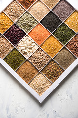 Indian Beans,Pulses,Lentils,Rice and Wheat grain in a white wooden box with cells, selective focus.
