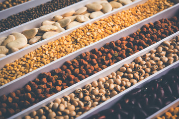 Indian Beans,Pulses,Lentils,Rice and Wheat grain in a white box with cells or strips, selective focus.