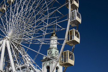 Ferris wheel against the cloudless sky