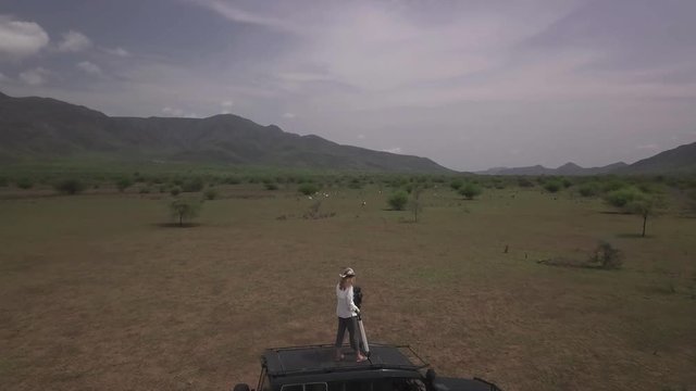 4K drone fly over of filmmaker recording footage in african location.