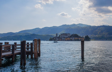 View of  San Giulio island from Orta San Giulio, Novara province, Italy.  it is part of the circuit of the most beautiful villages in Italy and is awarded the orange flag by the Italian Touring Club.
