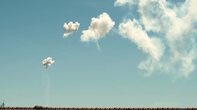 Smoky petards exploding like bombs in the sky above a roof.