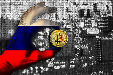 Bitcoin cryptocurrency Russia flag Binary code Golden Coin of Bitcoin in the Russian Federation flag hand between two fingers shows OK sign on a chip background
