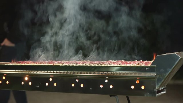 Burning grate cooking some arrosticini.