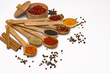 Spice. Spice in a wooden spoon. Herbs. Curry, saffron, turmeric, pepper and other isolated on white background.