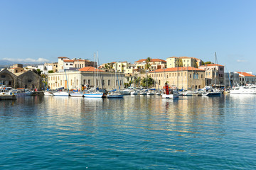 Fototapeta na wymiar View of the Venetian port of Chania with the center of mediterranean architecture, ships and pleasure boats