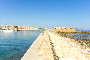 Lighthouse in the historical venetian port of Chania. The greek city on the north coast of Crete is one of the most beautiful towns on the island