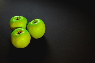 green apples on black background