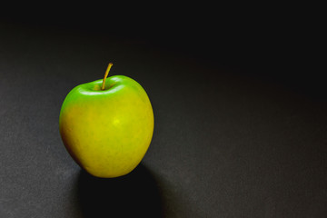 green apple on black background