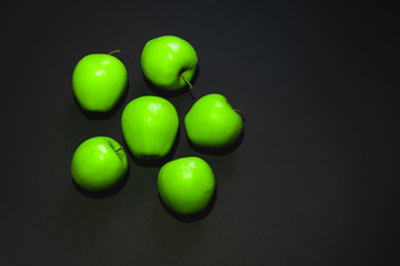 green apples on black background