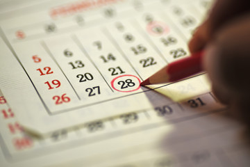 Twenty eighth Day of the month marked with marked in the calendar with red pencil