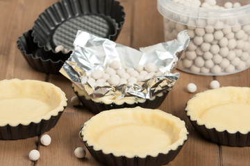 Cooking Process Of Tartlets. Ceramic Baking Beans. Tins.