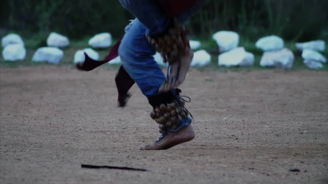 Close up shot, feet stomping, Native American Indian's dance in a circle ceremony.