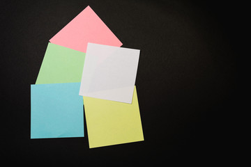 colored office paper for notes on a black background