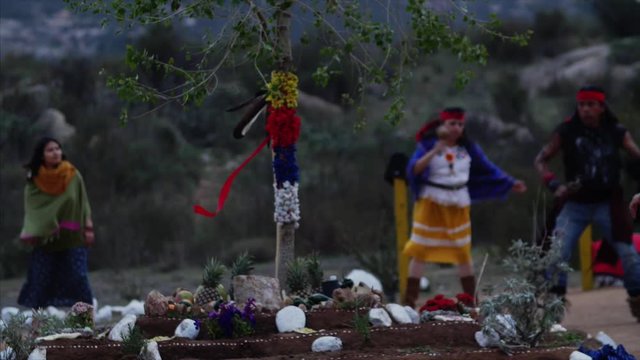 Native American Indians dance in ceremony, on sacred land, for the changes in season.