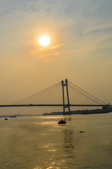 Fototapeta na wymiar View of second Hooghly Bridge Kolkata India taken at dusk, at dawn, at daytime in landscape style. The Subject of the image is, inspiration, exciting, hopeful, bright, sensational, tranquil, calm